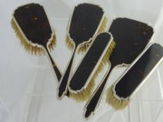 A Tortoiseshell Dressing Table Set comprising mirror, two hair brushes and two clothes brushes.