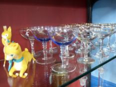 Thirteen Babycham Glasses together with two "Babycham Deer" figures and two blue glass champagne (