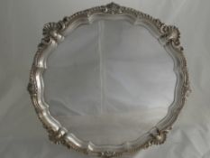 A Solid Silver Salver, with shell form edges on scroll feet, London hallmark, dated 1901, m.m JBC,