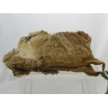 A Seal Skin Eskimo Child's Bonnet together with a pair of Reindeer skin mittens.