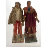 Two Antique Continental Wooden Dolls (possibly early 19th Century), with hand painted faces, the