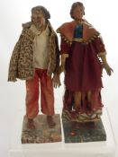 Two Antique Continental Wooden Dolls (possibly early 19th Century), with hand painted faces, the