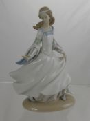 A Lladro Figure of a Young Girl Without a Shoe, approx 25 cms high.