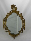 A Victorian Gilded Metal Wall Mirror, the mirror having lion mask to top with floral borders, approx