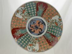 An Imari Plate decorated with panels depicting storks and iris flowers, approx 38 cms dia.