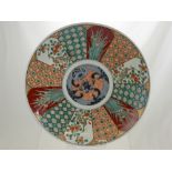 An Imari Plate decorated with panels depicting storks and iris flowers, approx 38 cms dia.