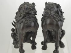 A Pair of Antique Bronze Dogs of Fo, the fearsome figures are depicted seated with finely carved