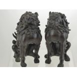 A Pair of Antique Bronze Dogs of Fo, the fearsome figures are depicted seated with finely carved