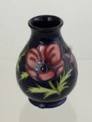 A Moorcroft Vase "Peony", nr 34/94 signed P.M approx 14 cms.