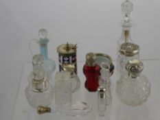 A Collection of Cut Glass Perfume Bottles, including some silver topped together with a Crown