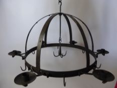 A Wrought Iron Game Crown with candle sconces and game hooks.