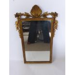 An Antique Gilt Mirror, with foliate ornament to the top, approx 60 x 95 cms