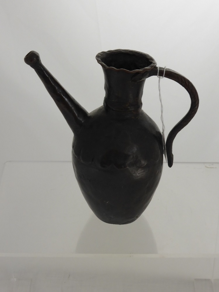 An Antique Bronze Ewer, with incised curved handle and straight spout, possibly 17th Century North