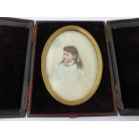 An Oval Victorian Portrait Miniature on Glass, depicting a young woman, in the original olive wood