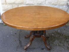 A Mahogany Inlaid late Victorian Loo Table, the table having a five column support on carved splayed