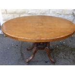 A Mahogany Inlaid late Victorian Loo Table, the table having a five column support on carved splayed