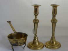 A Pair of 19th Century Brass Candle Sticks, together with a 19th Century skillet. (3)