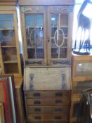 An Oak Arts & Crafts bureau book case with glazed cupboard, four drawers with copper hand made
