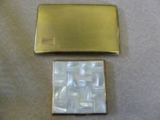 A Swiss Made Agme Powder Compact, the lid being mother of pearl, together with a gold coloured metal