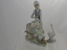 A Lladro Figure of a Girl holding a lamb approx 22 cms high and a figure of a goose. (2)