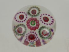 A Millefiori Style Paperweight, unsigned, with pink and green canes.