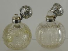 Two Cut Glass Silver Topped Perfume Bottles, both with the original stoppers, the first bottle