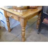 A Pine Table with turned legs and drawer to one side, approx 74 x 91 x 77 cms.