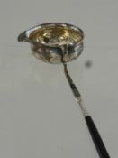 A Georgian Brandy Ladle, having twisted stem, inset with 1758 silver six pence to bowl, waf.
