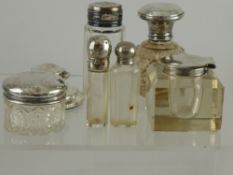 Quantity of Cut Glass and Silver Topped Perfume Bottles, together with a silver topped travelling