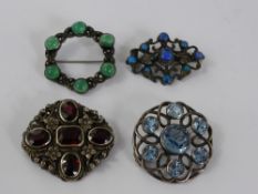 A Miscellaneous Collection of Silver Brooches, including blue glass, jade, garnet and silver metal