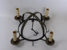 An Antique Cast Iron Game Crown, with candle sconce and game hooks.