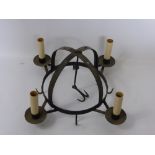 An Antique Cast Iron Game Crown, with candle sconce and game hooks.