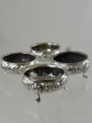 A Set of Four Victorian Silver Salts, having floral embellishment to bowl, stood on hoof feet,