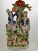 A 19th Century Staffordshire Flatback Figure, depicting a Highland Couple stood against a tree