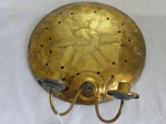 An Arts and Crafts Brass Wall Sconce, in the form of a shield, with decorative piercing.