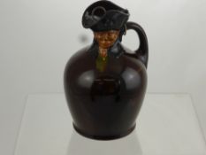 An Antique Royal Doulton Flagon, depicting a gentleman, with the original stopper, approx 21 cms.