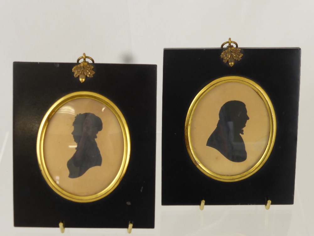 A Pair of Georgian Silhouettes, presented in ebony frames depicting a lady and gentleman, approx 9 x