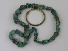 An Unpolished Graduated Turquoise Necklace, together with a turquoise bangle. (2)