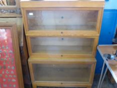 Three Globe Wernicke Limited stacking pine glazed lift top book cases, approx 86 x 36 x 121 cms.