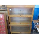 Three Globe Wernicke Limited stacking pine glazed lift top book cases, approx 86 x 36 x 121 cms.