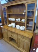 A Pine Cottage Dresser, with glazed cupboards on either side of three shelves, four short drawers