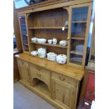 A Pine Cottage Dresser, with glazed cupboards on either side of three shelves, four short drawers