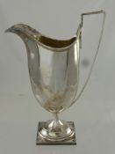 An Antique Silver Regency Style Sauce Jug, having reeded edge and handle on square foot, Sheffield