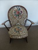 An Ercol Rocking Chair in the Windsor Style, with floral embroidered back and seat.