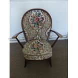 An Ercol Rocking Chair in the Windsor Style, with floral embroidered back and seat.