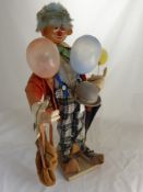 A Character Felt Figure depicting a Clown, the clown dressed in orange jacket and check trousers,