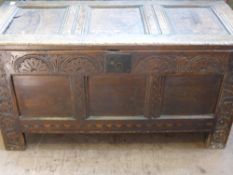 A Circa 18th Century Oak Chest, the having a carved panelled front with inlayto bottom, on