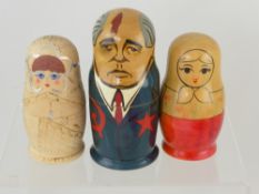 Three Semenov Russian Dolls, two depicting ladies and the third a Pugachev character.