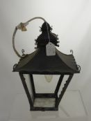 A wrought iron coaching lamp.