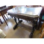 An Antique Stained Oak Jacobean Style Hall Table, with elaborate carving to the skirt with lion mask